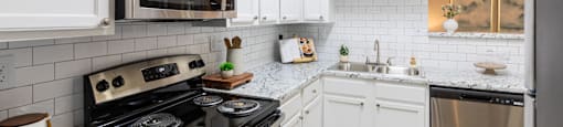 a kitchen with stainless steel appliances and marble counter tops