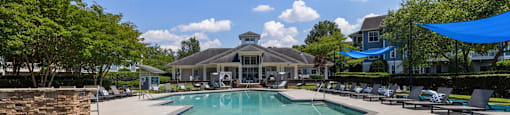 the resort style pool is surrounded by lounge chairs and umbrellas