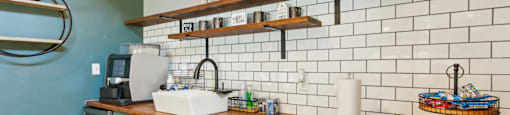 A kitchen with a blue wall and a wooden counter.
