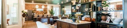 A modern kitchen with a bar area and a dining table.