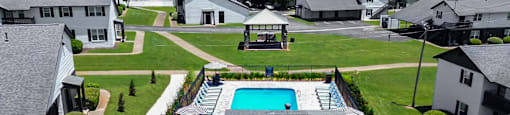 A swimming pool in a backyard surrounded by a fence.