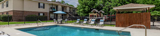 the preserve at ballantyne commons resort style swimming pool with chairs and trees