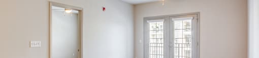 the living room and dining room of an empty house with a ceiling fan