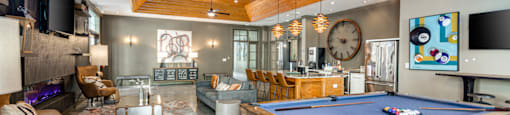 a large living room with a pool table and a tv