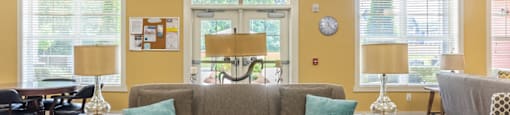 a living room filled with furniture and a large window