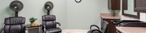 a treatment room with chairs and a sink