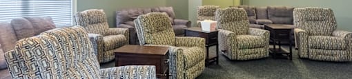 a living room with couches and chairs