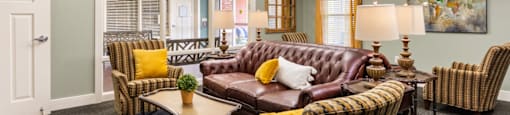 a living room filled with furniture and a large window
