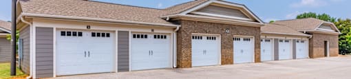 the front of a house with a row of garages