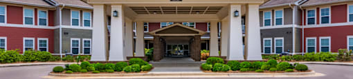 a large building with a large entrance with a blue sky in the background
