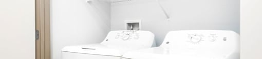 a washer and dryer in a room with a door