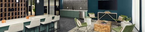 A modern living room with a grey floor and a dark blue wall at Boardwalk at Research Park apartments in Huntsville, AL.
