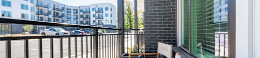 a modern balcony with classy outdoor furniture and contemporary decoration.
