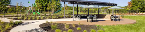 A playground with a slide and a canopy at Boardwalk at Research Park apartments in Huntsville, AL.