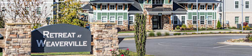 the view of retreat at weaverville with a sign in front of a building