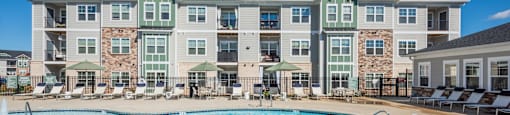 a swimming pool with an apartment building in the background