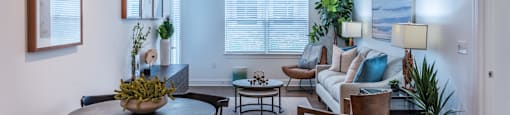 a living room with a couch and a table and chairs