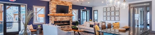 a large living room with a kitchen and a fireplace