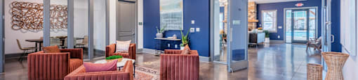 a lobby with couches and chairs and glass doors