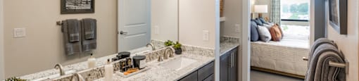 A bathroom with a double sink vanity and a mirror above it at 27Seventy Lower Heights apartments in Houston, TX.