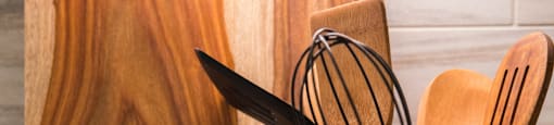 Wooden utensils are placed in a container on a countertop at 27Seventy Lower Heights apartments in Houston, TX.