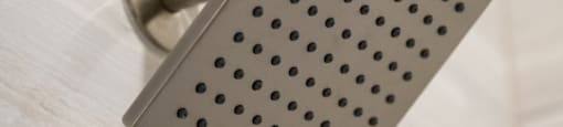 A shower head mounted on a wall at 27Seventy Lower Heights apartments in Houston, TX.