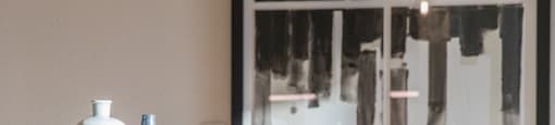 A row of chairs are lined up in front of a painting at 27Seventy Lower Heights apartments in Houston, TX.