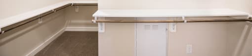 Empty white shelves in a walk in closet at 27Seventy Lower Heights apartments in Houston, TX.