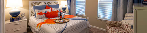 Two Bedroom Apartments in Myrtle Beach SC - Lattitude @ The Commons - Bedroom With a Ceiling Fan, Plush Carpeting, and Large Windows