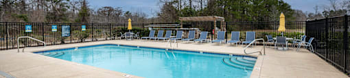 sparking swimming pool with large pool deck for lounging