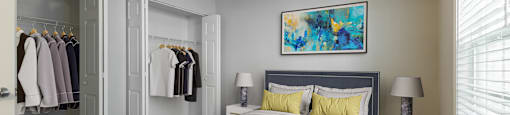 a bedroom with a large bed and a walk in closet