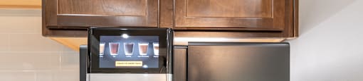 a coffee maker and a refrigerator on a kitchen counter