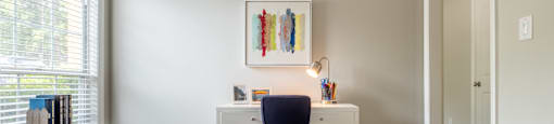 a bedroom with a desk and chair in a 555 waverly unit