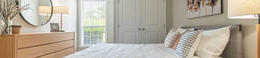 a bedroom with a large bed and a ceiling fan