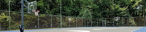 a tennis court with a basketball hoop on it