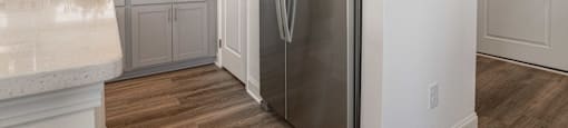 A modern kitchen with a stainless steel refrigerator.