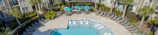 an aerial view of a swimming pool at an apartment complex