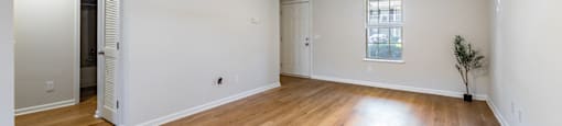 A room with wooden floors and a ceiling fan.