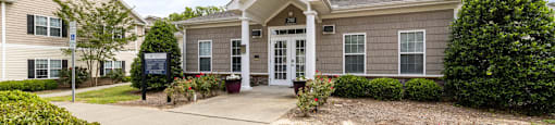 the front of a house with a walkway and a driveway
