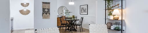 a living room with two white chairs and a ceiling fan