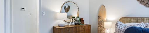 a bedroom with a bed and a dresser with a mirror