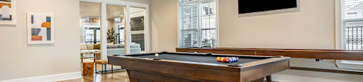 a game room with a pool table and a tv
