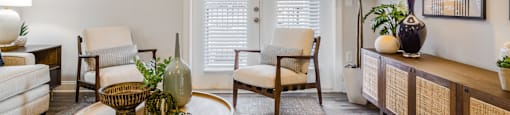 a living room with a table and chairs and a door