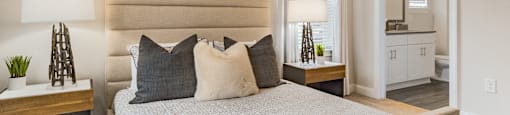 a bedroom with a large bed and a mirror