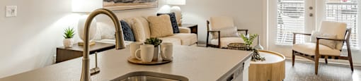a living room with a kitchen counter top and a sink