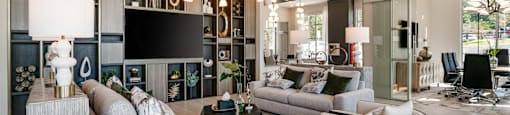 a living room with couches and chairs and a television