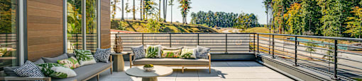 a patio with chairs and tables on a balcony