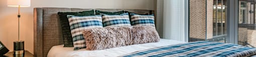 a bedroom with a bed and a large window