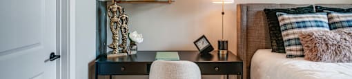 a bedroom with a bed and a desk with a chair