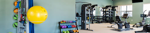 a large fitness room with weights and other exercise equipment
